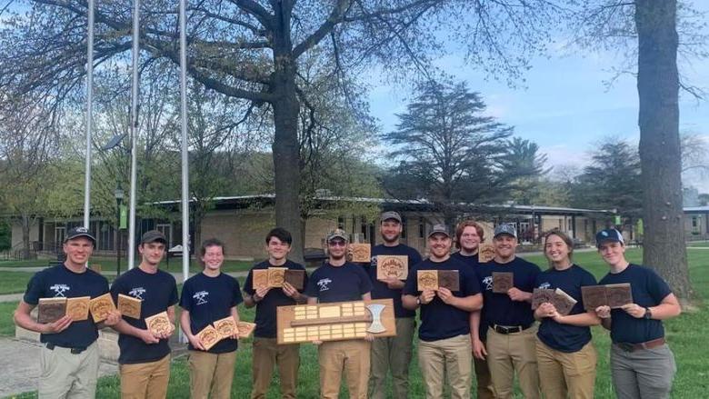 Members of the 2023 Woodsmen Team hold plaques after winning first place at the 2023 Mid-Atlantic Woodsmen's Meet